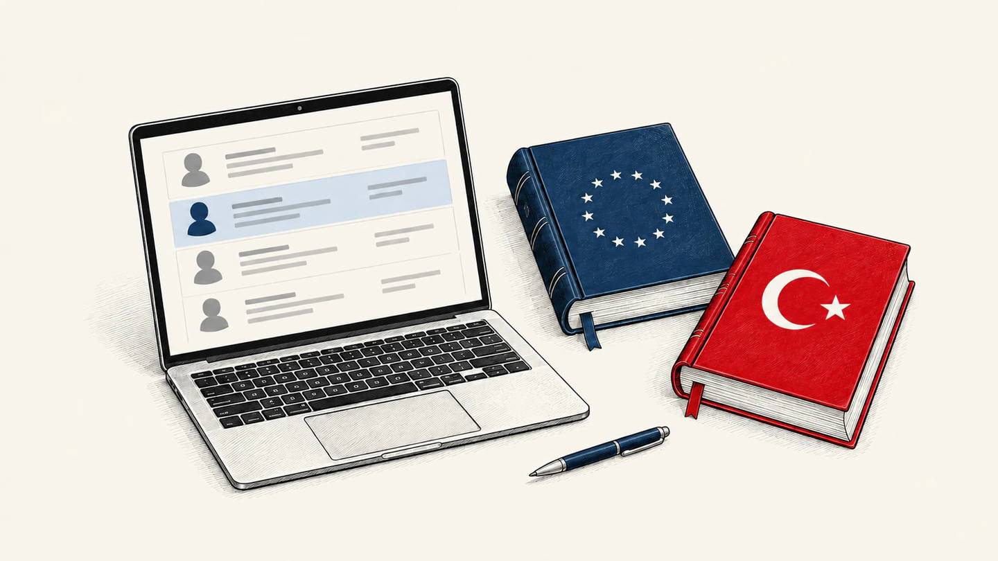 A laptop displaying customer records sits beside a navy law book with EU stars and a red law book with a white Turkish crescent and star.