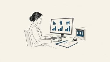 A hotel employee reviews spending charts for families, couples and groups of friends on a computer.